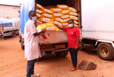 Annet Kakibibi, AAR staff (right) handing over the food relief support to the National Strategic Food Reserve representative on 05th May 2020.
