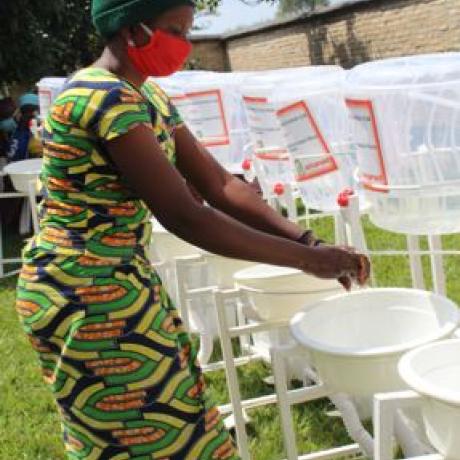Beneficiary of AAR Handwashing facilities in Nyanza District washing hands